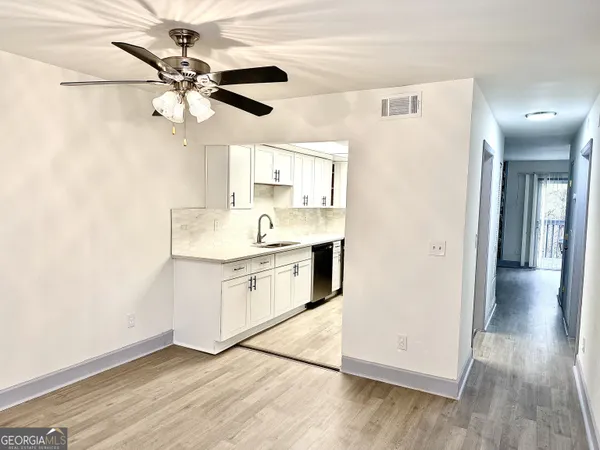a kitchen with stainless steel appliances a white and stove top oven
