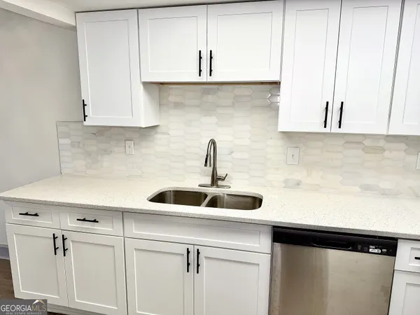 a kitchen with a sink and cabinets