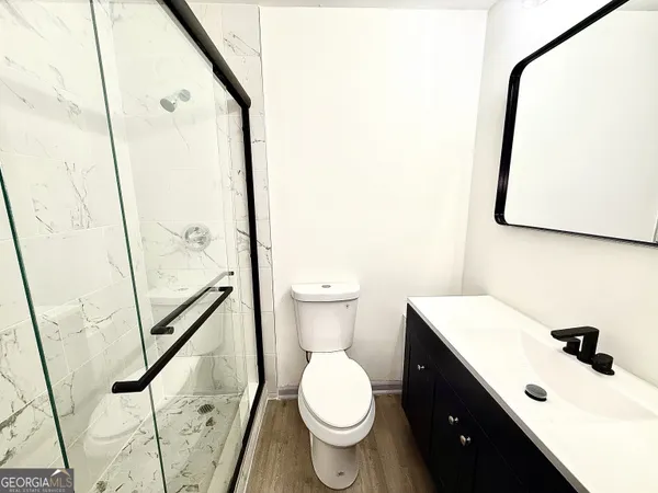 a bathroom with a toilet sink and a mirror