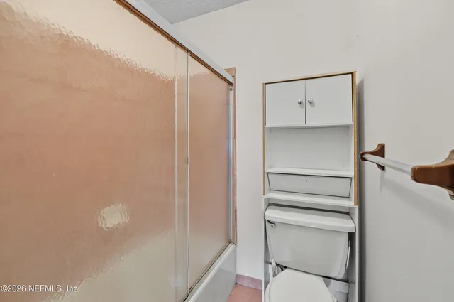 a bathroom with a shower and a toilet