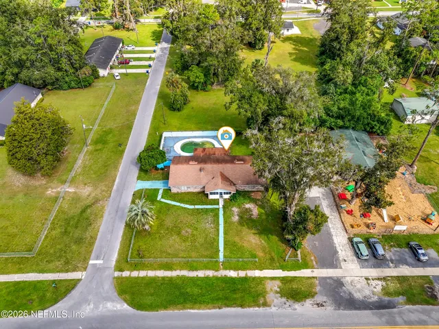 an aerial view of a houses with a yard