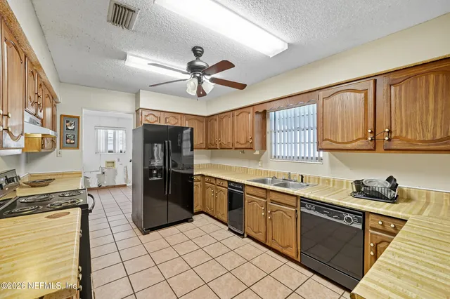 a kitchen with stainless steel appliances granite countertop a stove sink and cabinets