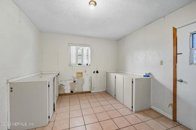 a view of a storage & utility room with a sink