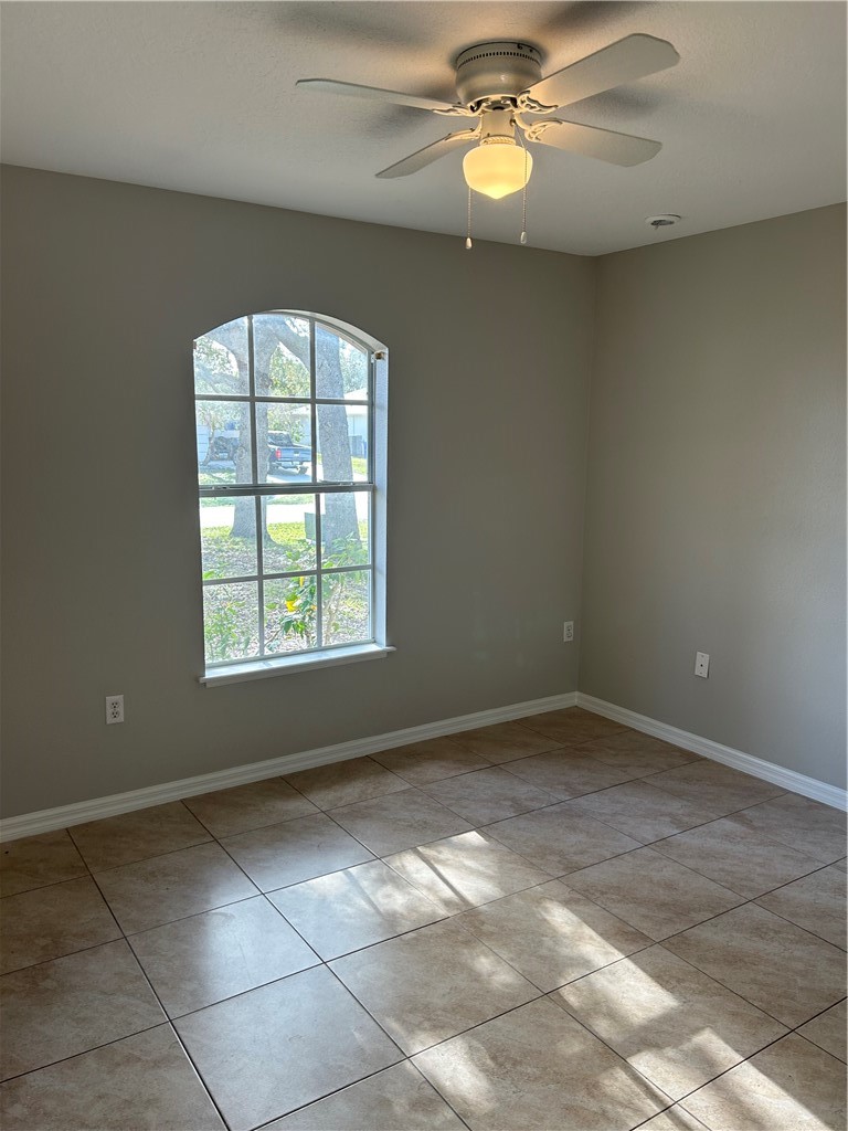 486 Biscayne Lane Sebastian, FL 32958 - Photo 2 of 15 en empty room with windows and ceiling fan