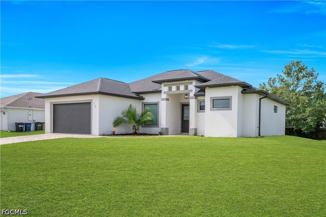 3509 38th Street Southwest Lehigh Acres, FL 33976 - Photo 5 of 47 a front view of a house with a yard and garage