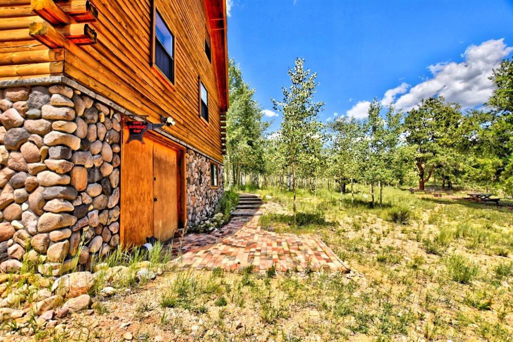 8614 Remington Road Como, CO 80432 - Photo 11 of 35 a backyard of a house with large trees