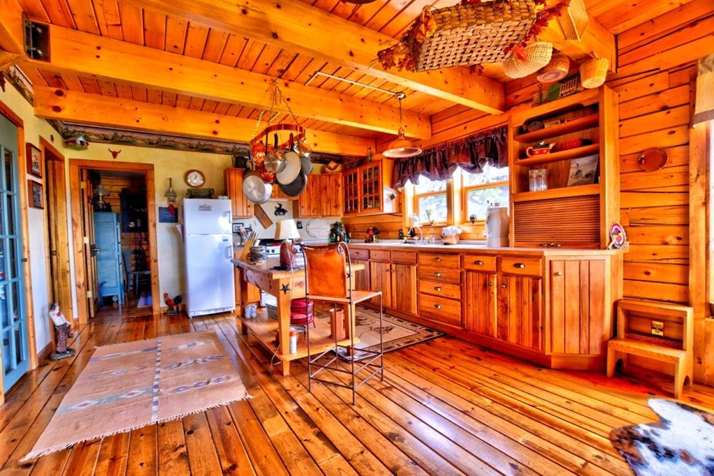8614 Remington Road Como, CO 80432 - Photo 23 of 35 a view of a patio with wooden floor and iron chairs
