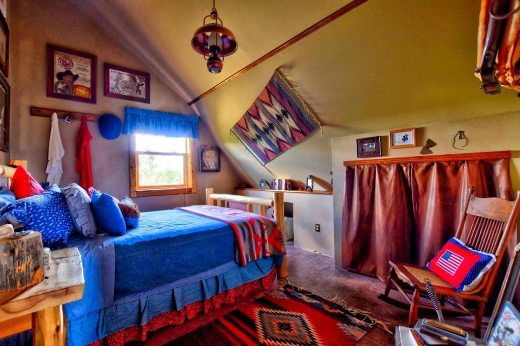 8614 Remington Road Como, CO 80432 - Photo 33 of 35 a bed room with a bed and a book shelf