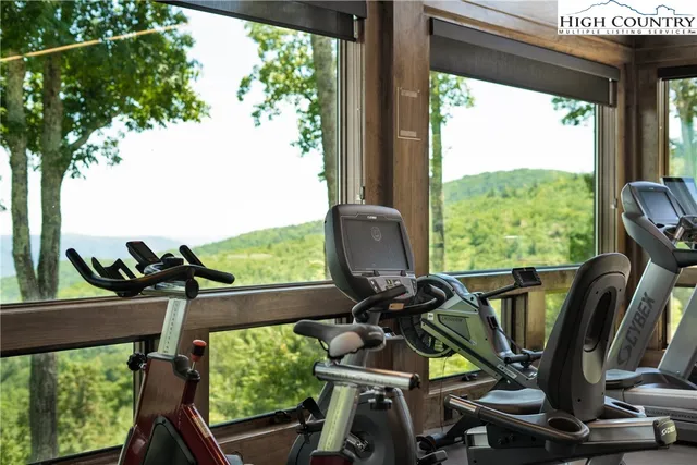 a view of a balcony with chairs and wooden floor