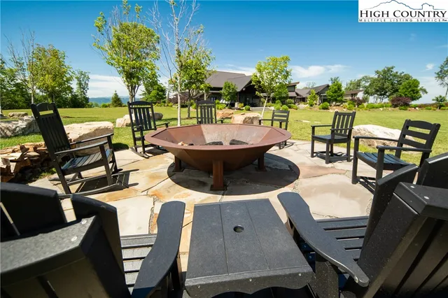 a view of a patio with table and chairs under an umbrella