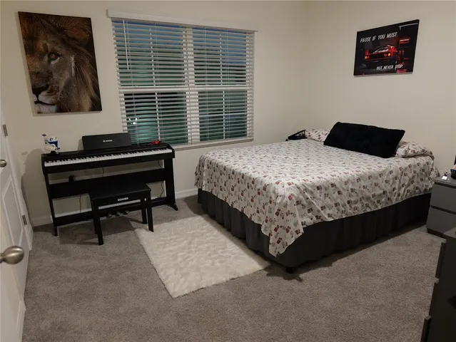 a living room with couches and a fireplace with windows