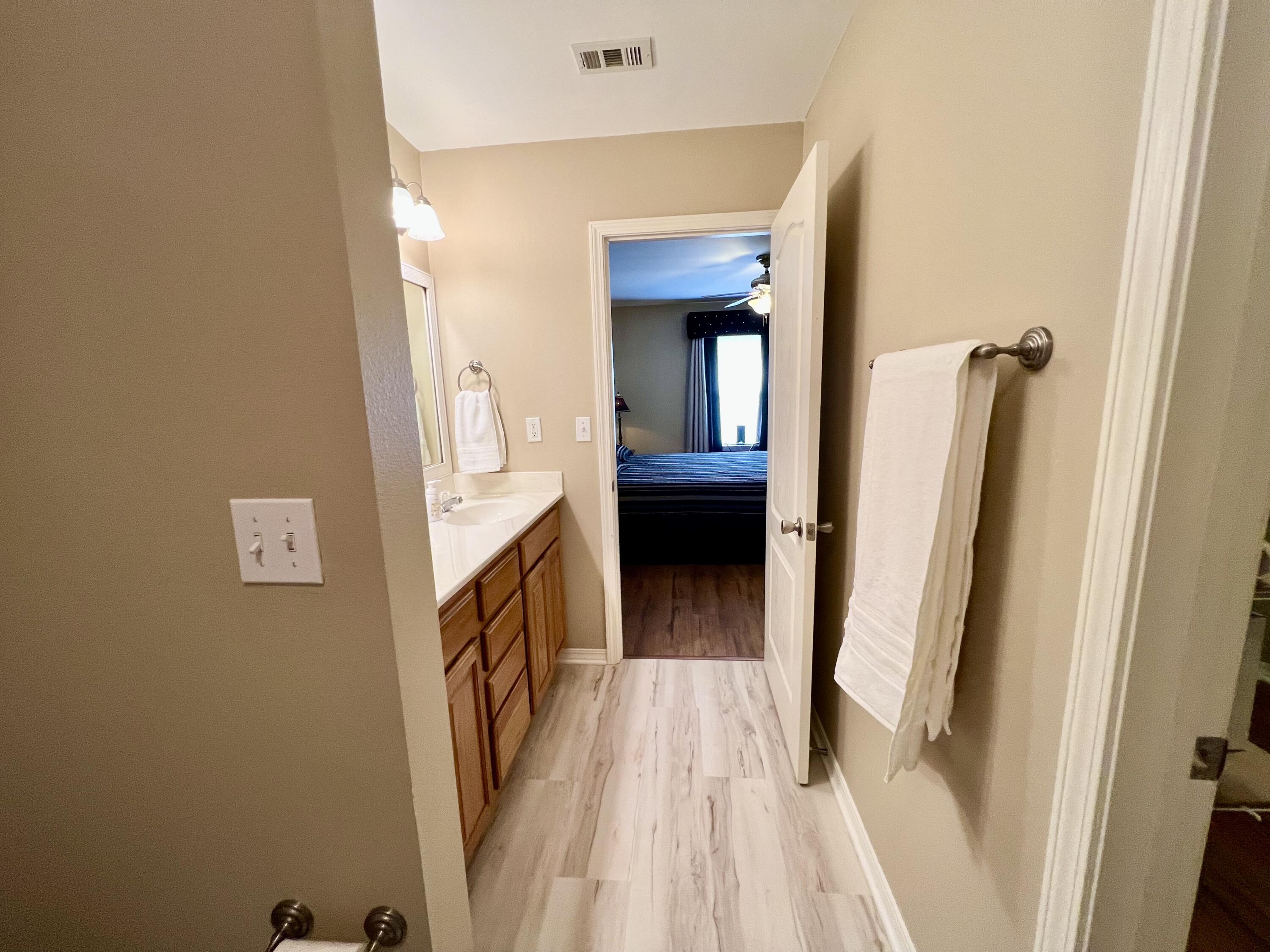 4645 Dove Way Crestview, FL 32539 - Photo 12 of 21 a view of a hallway with wooden floor and staircase