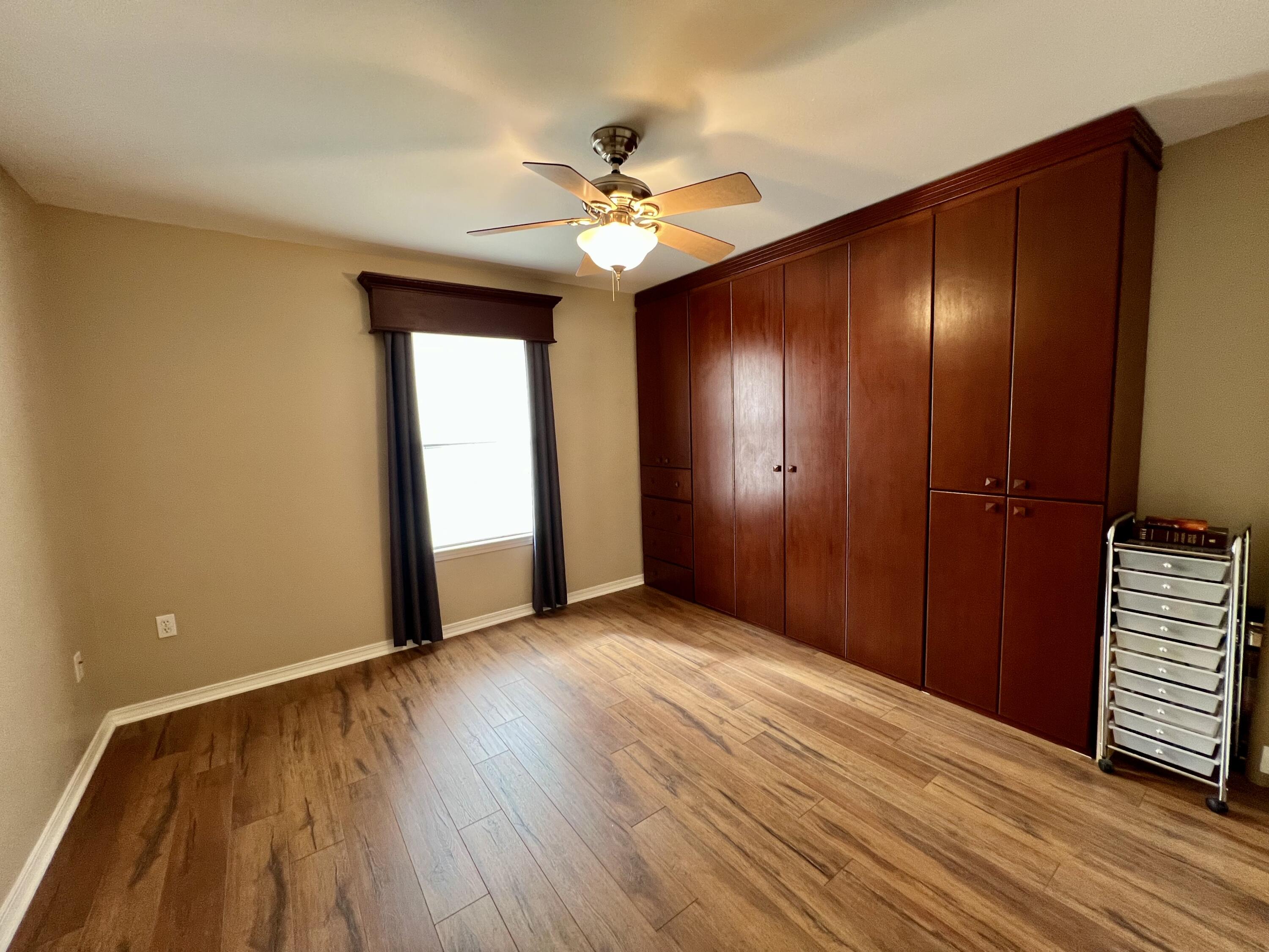 4645 Dove Way Crestview, FL 32539 - Photo 15 of 21 a view of an empty room with wooden floor and a ceiling fan