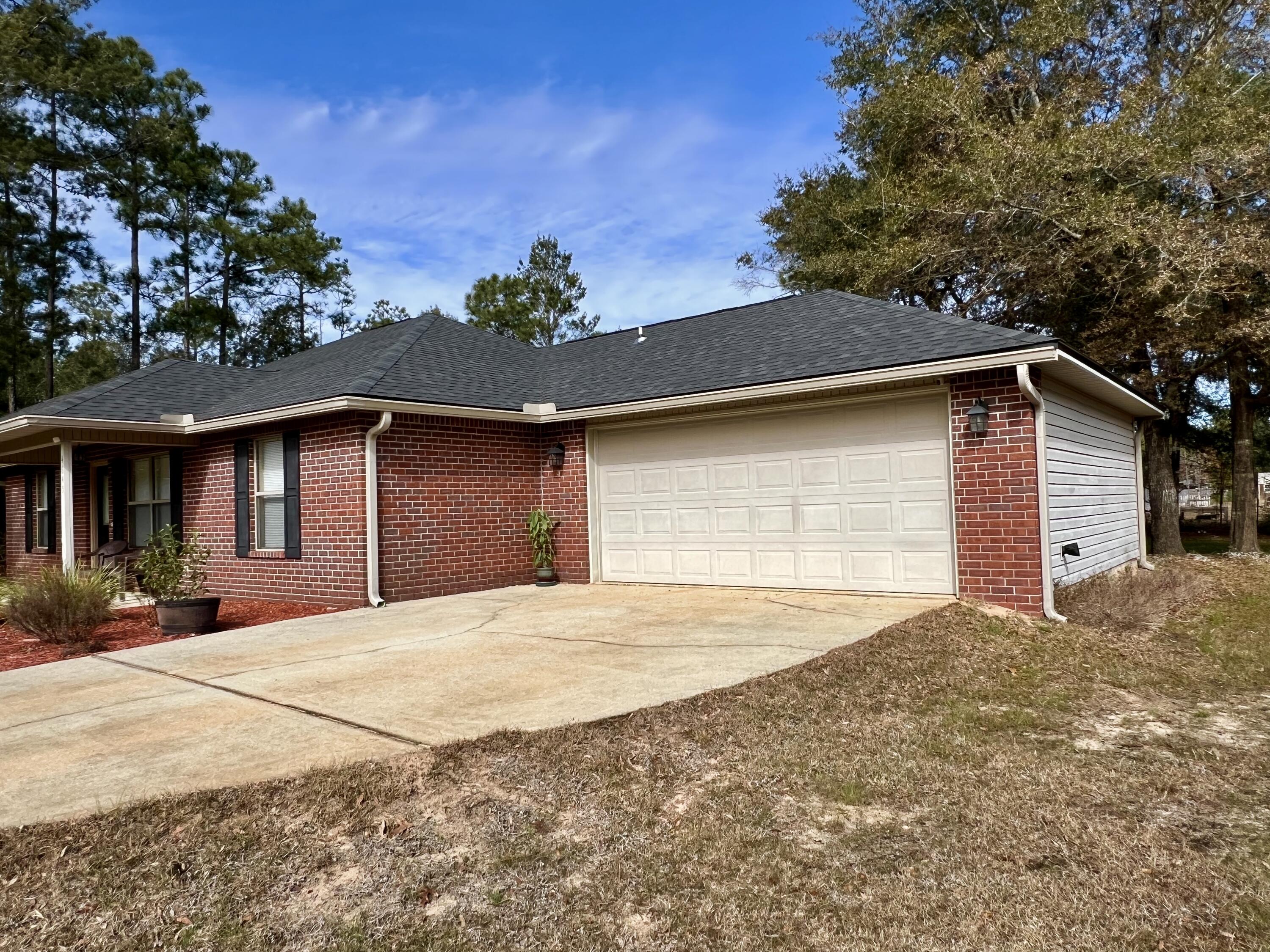 4645 Dove Way Crestview, FL 32539 - Photo 17 of 21 a front view of a house with a yard and garage