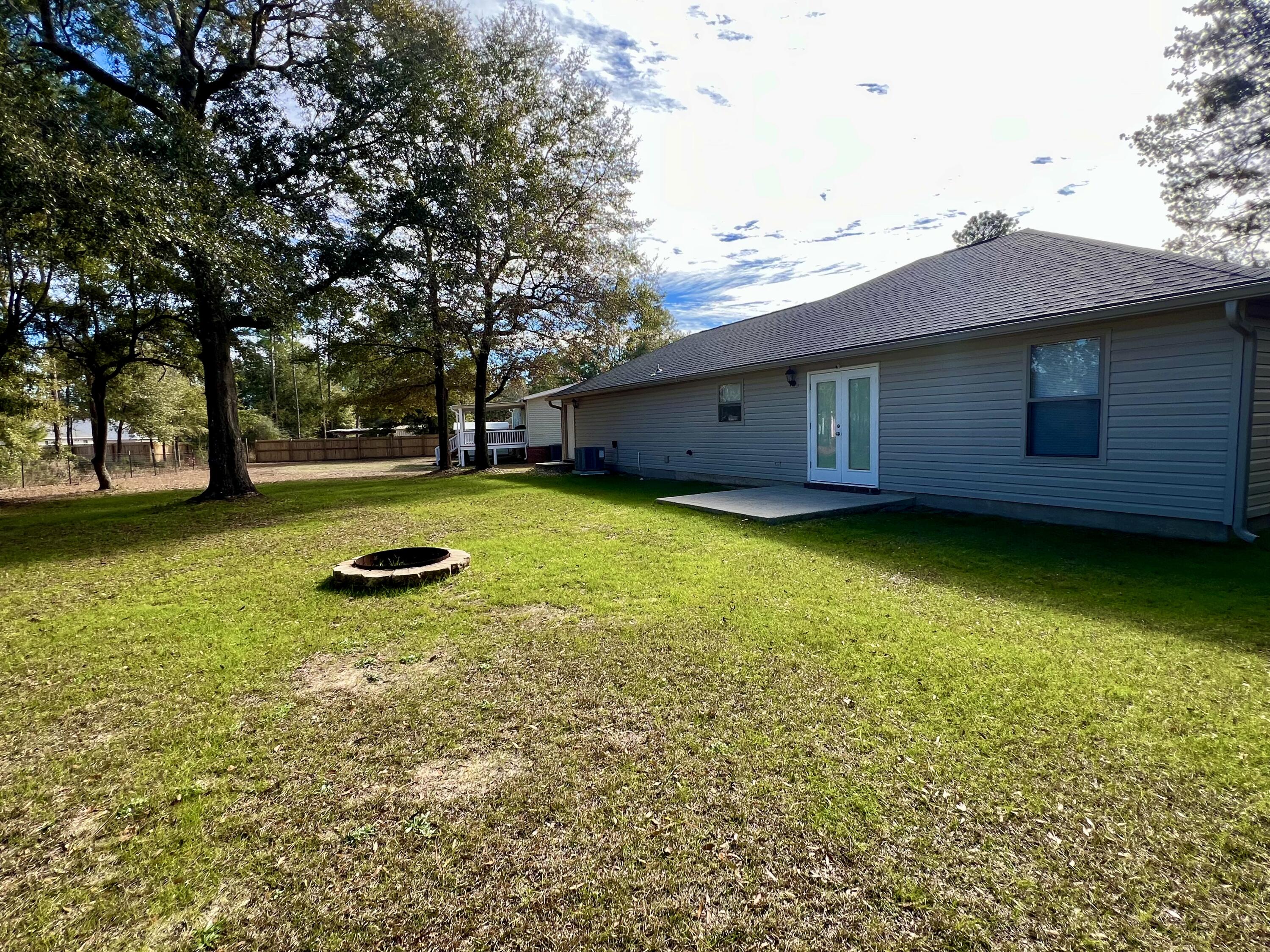 4645 Dove Way Crestview, FL 32539 - Photo 20 of 21 a view of a swimming pool and lounge chairs