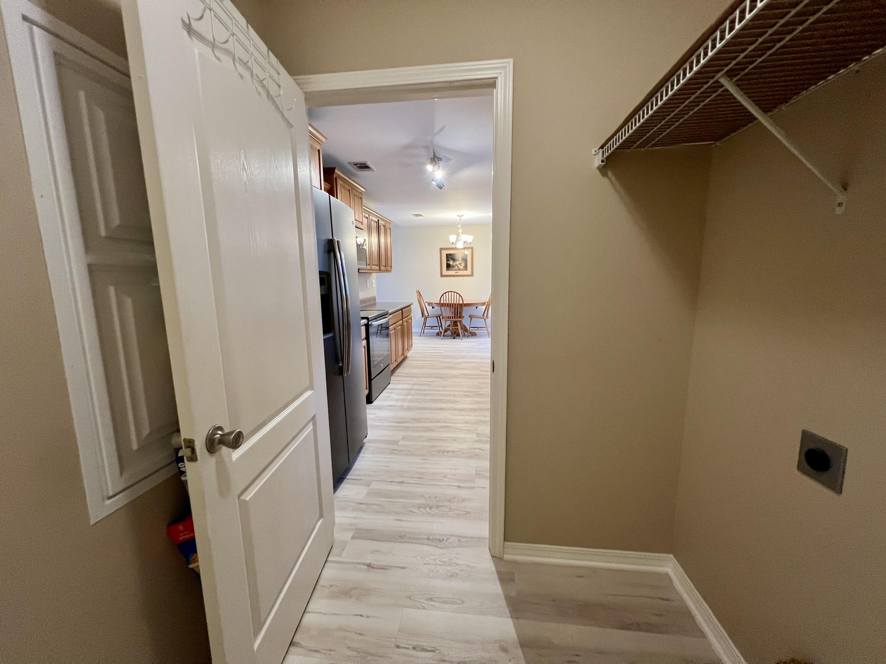 4645 Dove Way Crestview, FL 32539 - Photo 7 of 21 a view of a hallway with wooden floor and staircase