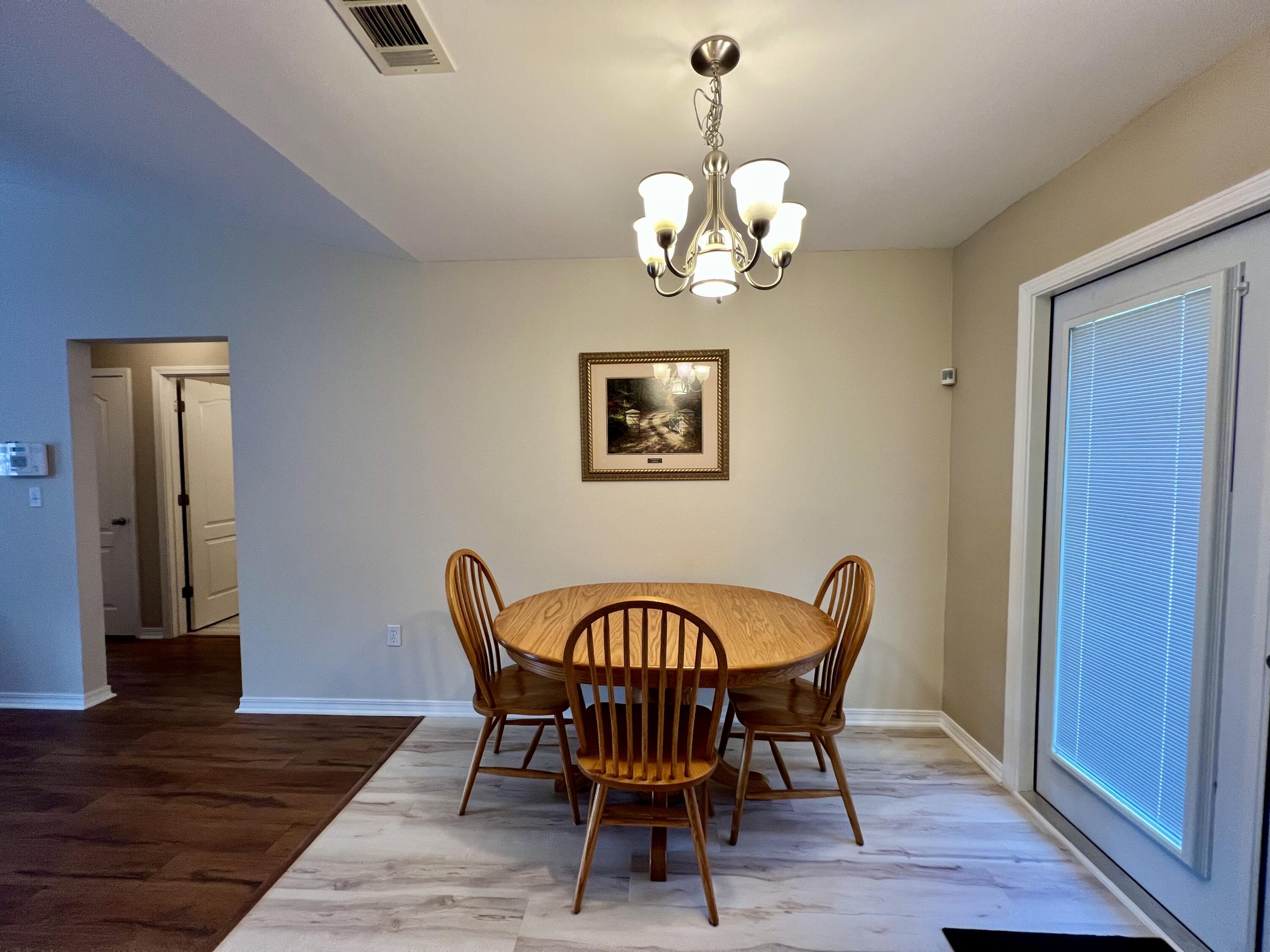 4645 Dove Way Crestview, FL 32539 - Photo 8 of 21 a view of a dining room with furniture wooden floor and chandelier