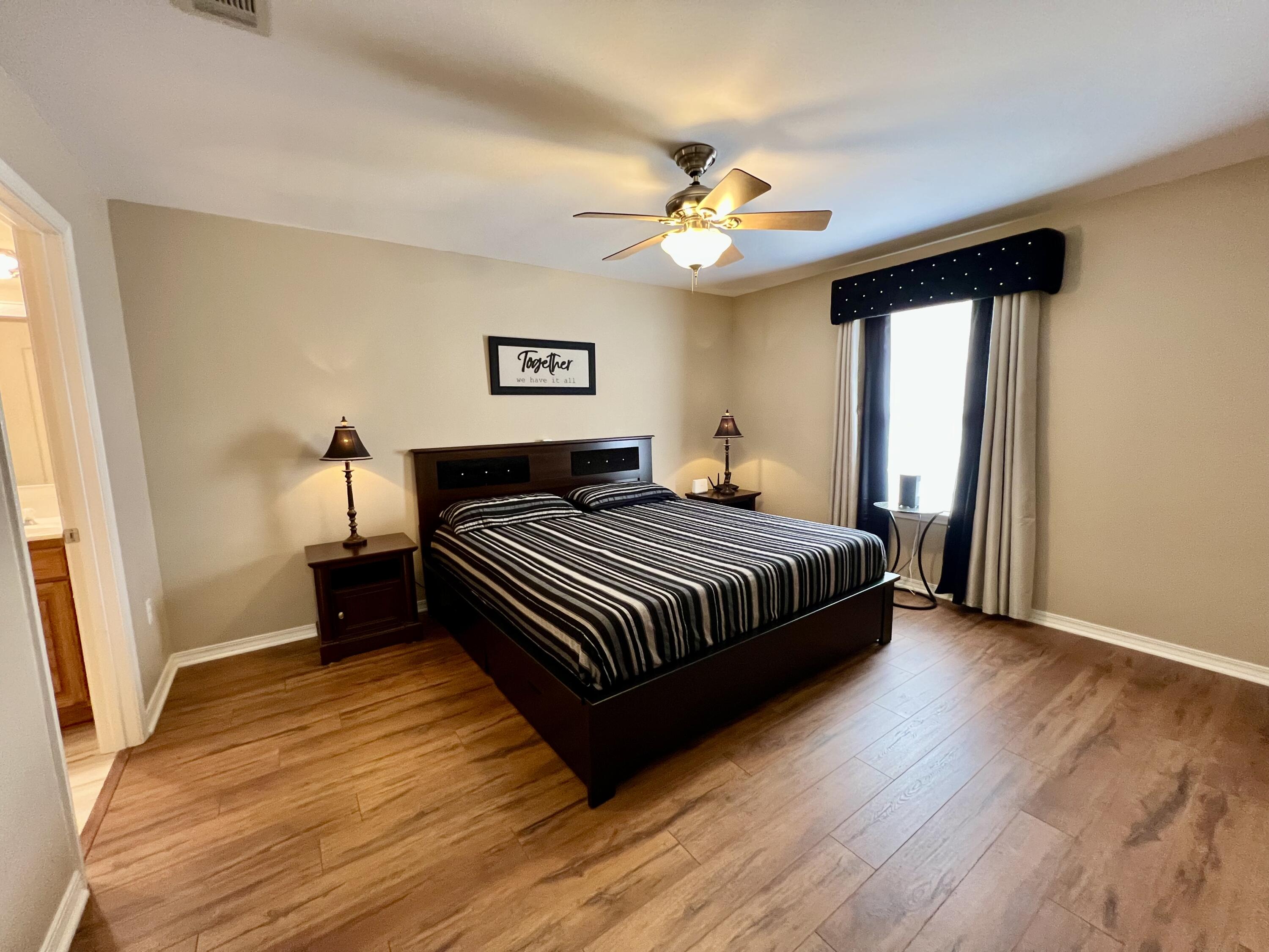 4645 Dove Way Crestview, FL 32539 - Photo 9 of 21 a bedroom with a bed and a chandelier