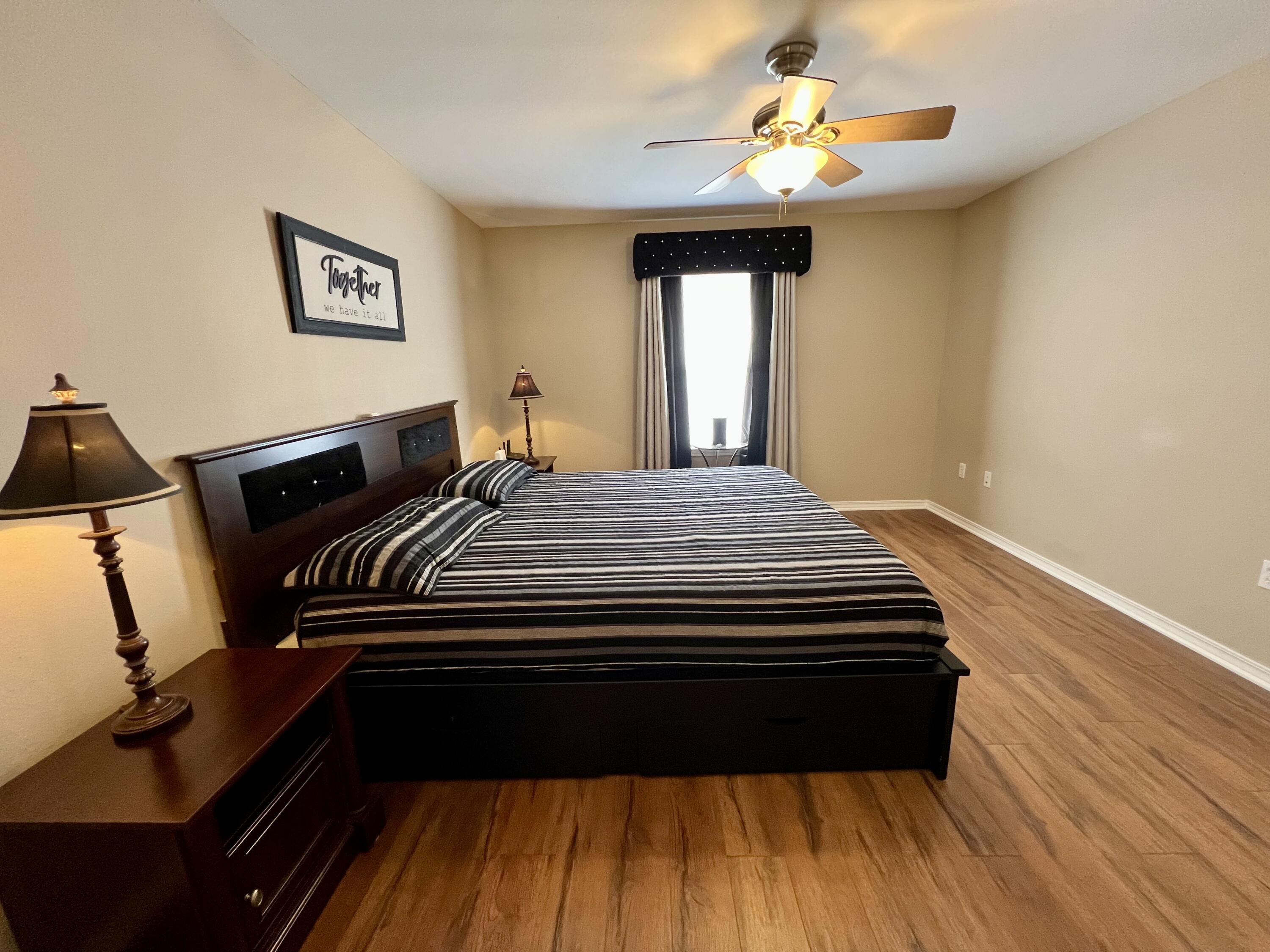 4645 Dove Way Crestview, FL 32539 - Photo 10 of 21 a bedroom with a bed and wooden floor