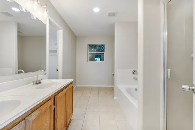 a bathroom with a sink a mirror and a bathtub