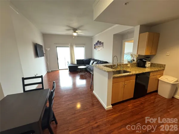a view of a kitchen counter space and wooden floor