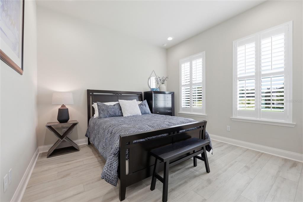 10776 Southwest 36th Place Gainesville, FL 32608 - Photo 23 of 44 a bedroom with a bed and wooden floor