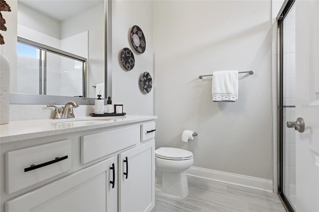 10776 Southwest 36th Place Gainesville, FL 32608 - Photo 30 of 44 a bathroom with a toilet sink and mirror