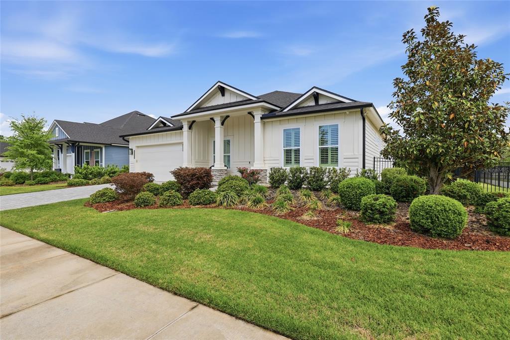 10776 Southwest 36th Place Gainesville, FL 32608 - Photo 43 of 44 a front view of a house with a yard and trees