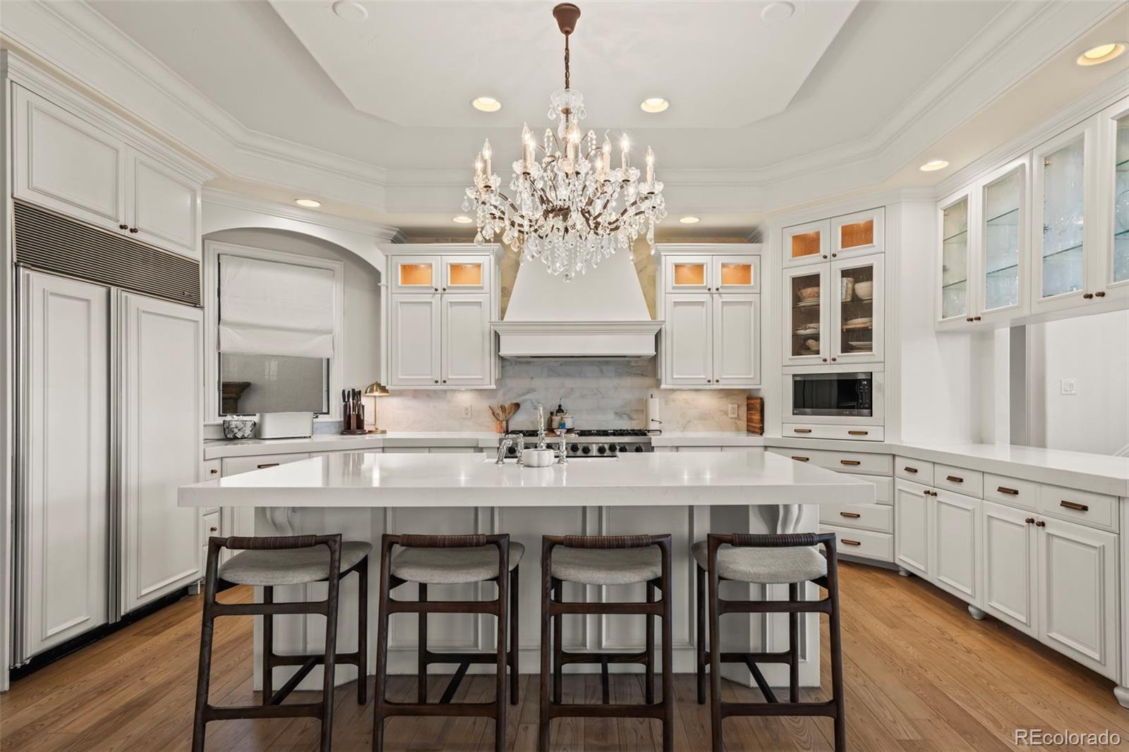 1012 Michener Way Highlands Ranch, CO 80126 - Photo 11 of 50 a kitchen with cabinets a center island and appliances