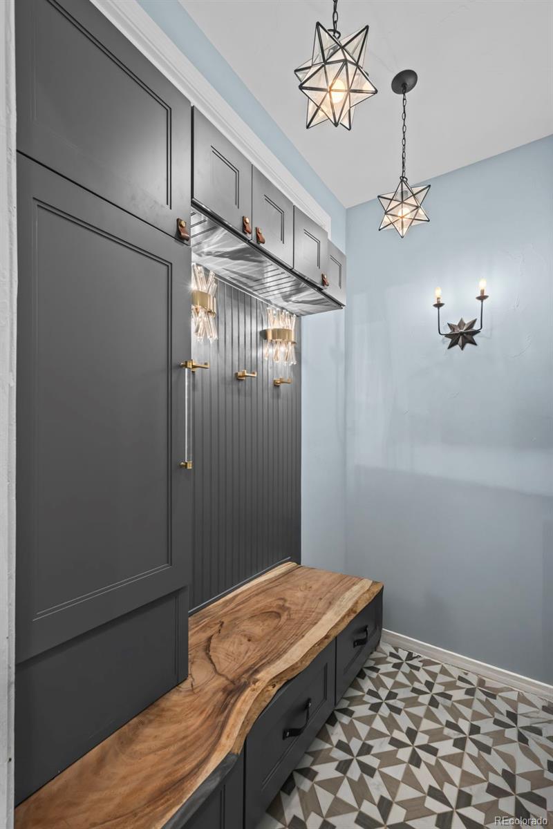 1012 Michener Way Highlands Ranch, CO 80126 - Photo 17 of 50 a bedroom with a bed and a chandelier fan