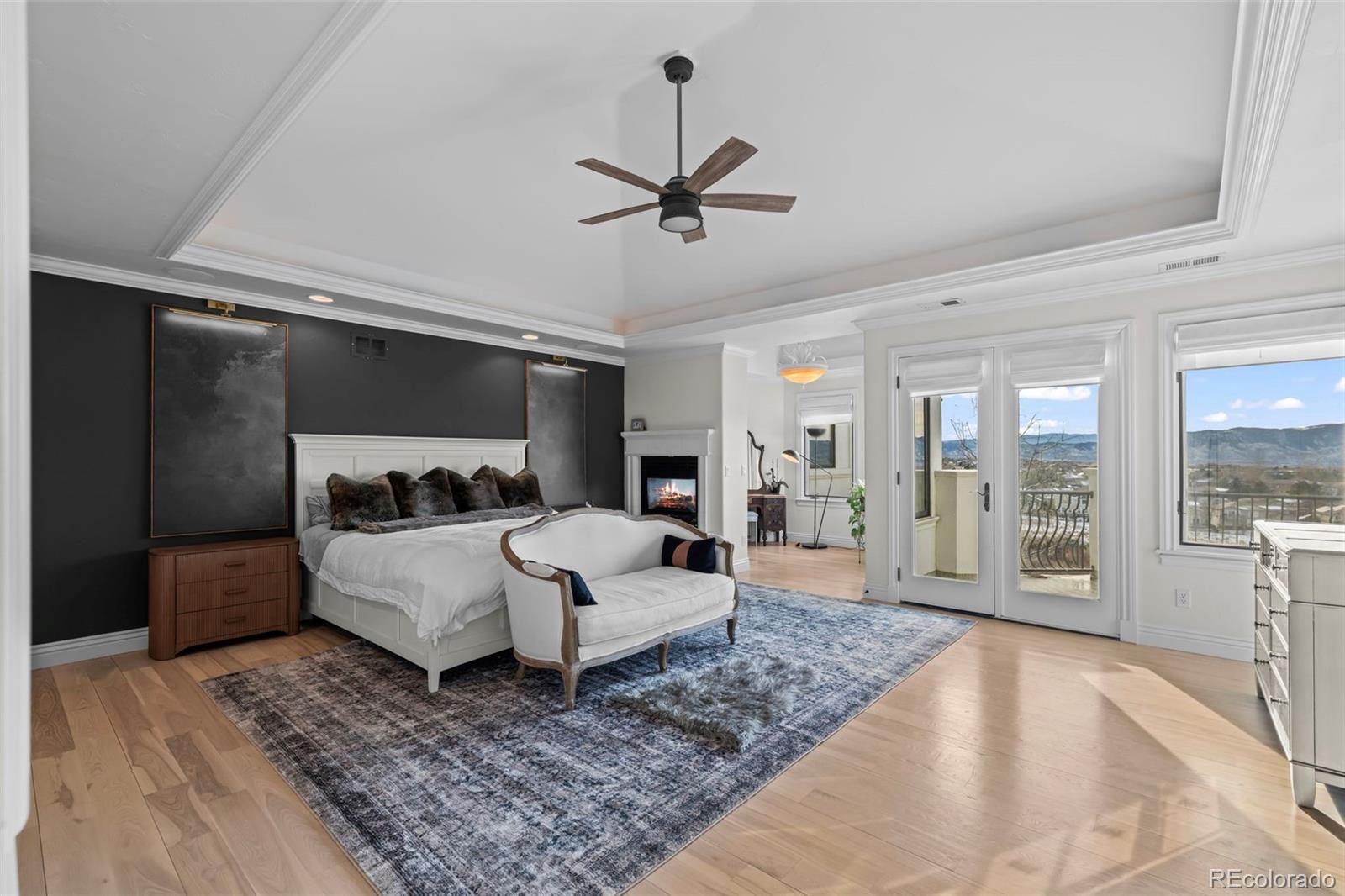 1012 Michener Way Highlands Ranch, CO 80126 - Photo 19 of 50 a bedroom with a large bed and a couch