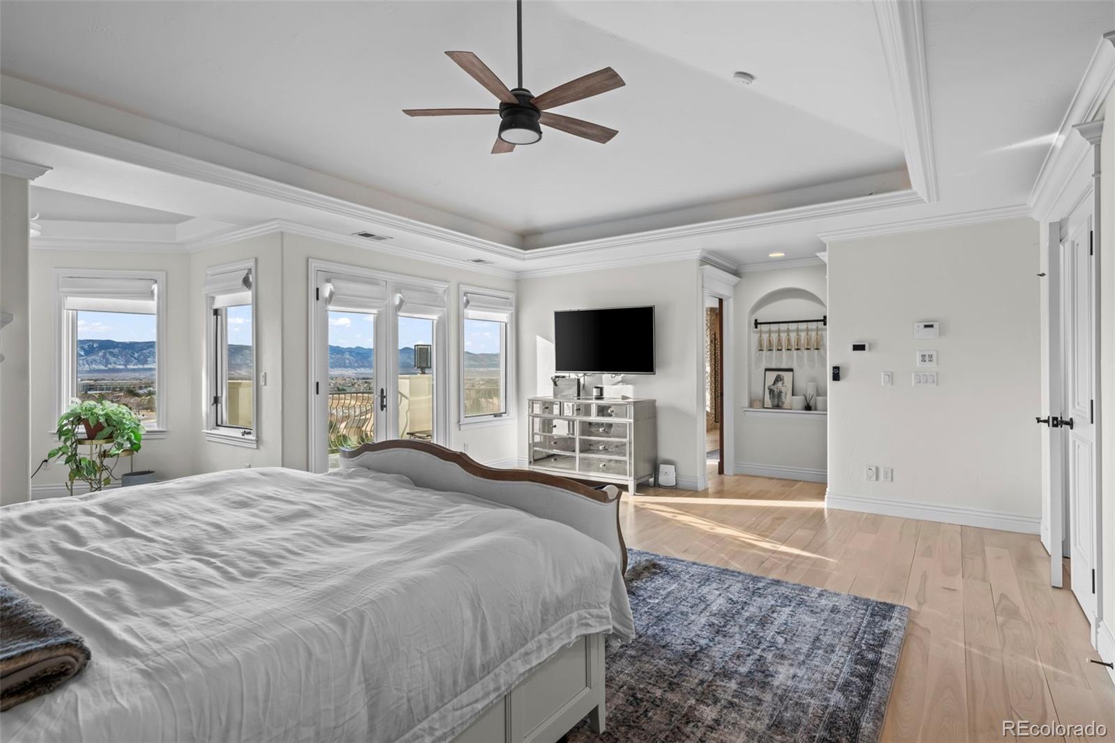 1012 Michener Way Highlands Ranch, CO 80126 - Photo 20 of 50 a spacious bedroom with a bed and a flat screen tv