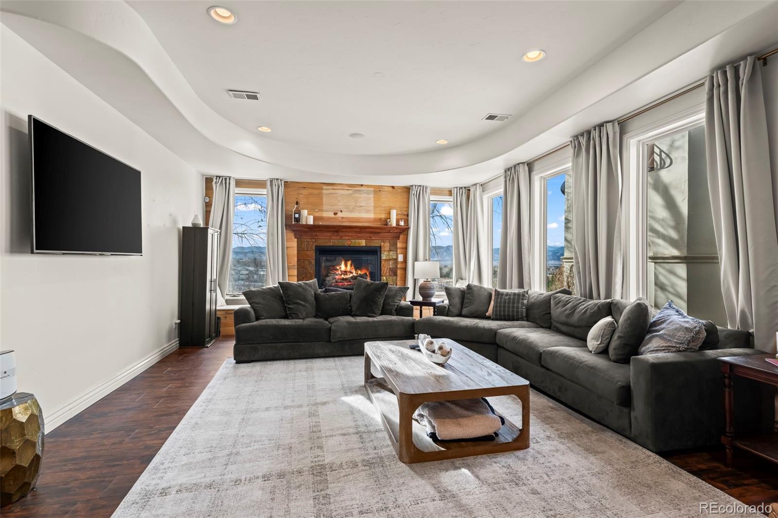 1012 Michener Way Highlands Ranch, CO 80126 - Photo 33 of 50 a living room with furniture and a flat screen tv