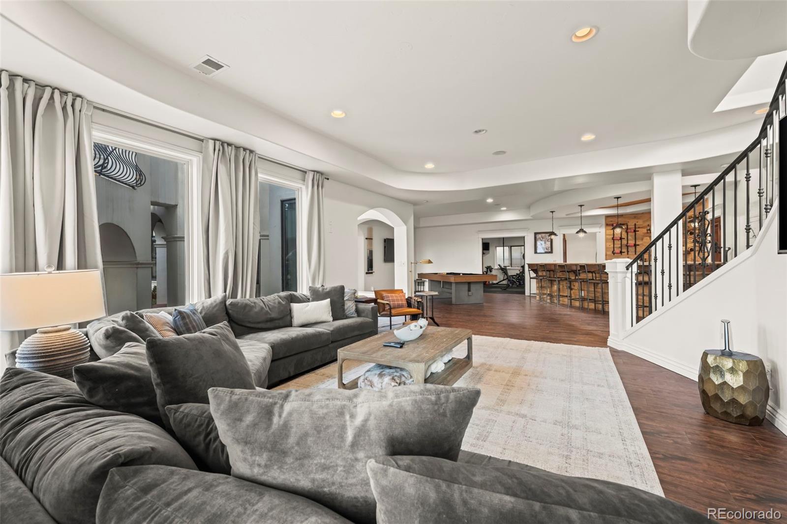 1012 Michener Way Highlands Ranch, CO 80126 - Photo 34 of 50 a living room with furniture and wooden floor