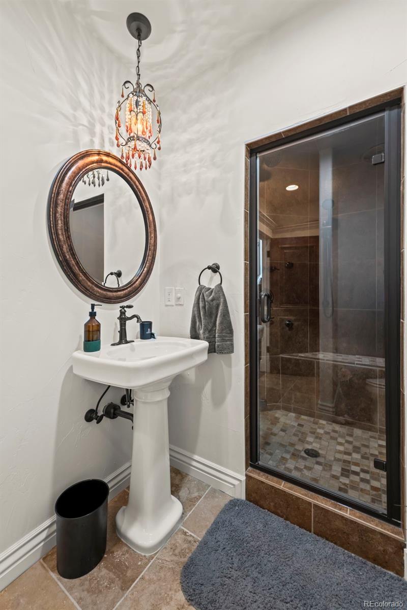 1012 Michener Way Highlands Ranch, CO 80126 - Photo 37 of 50 a bathroom with a sink a mirror and a shower