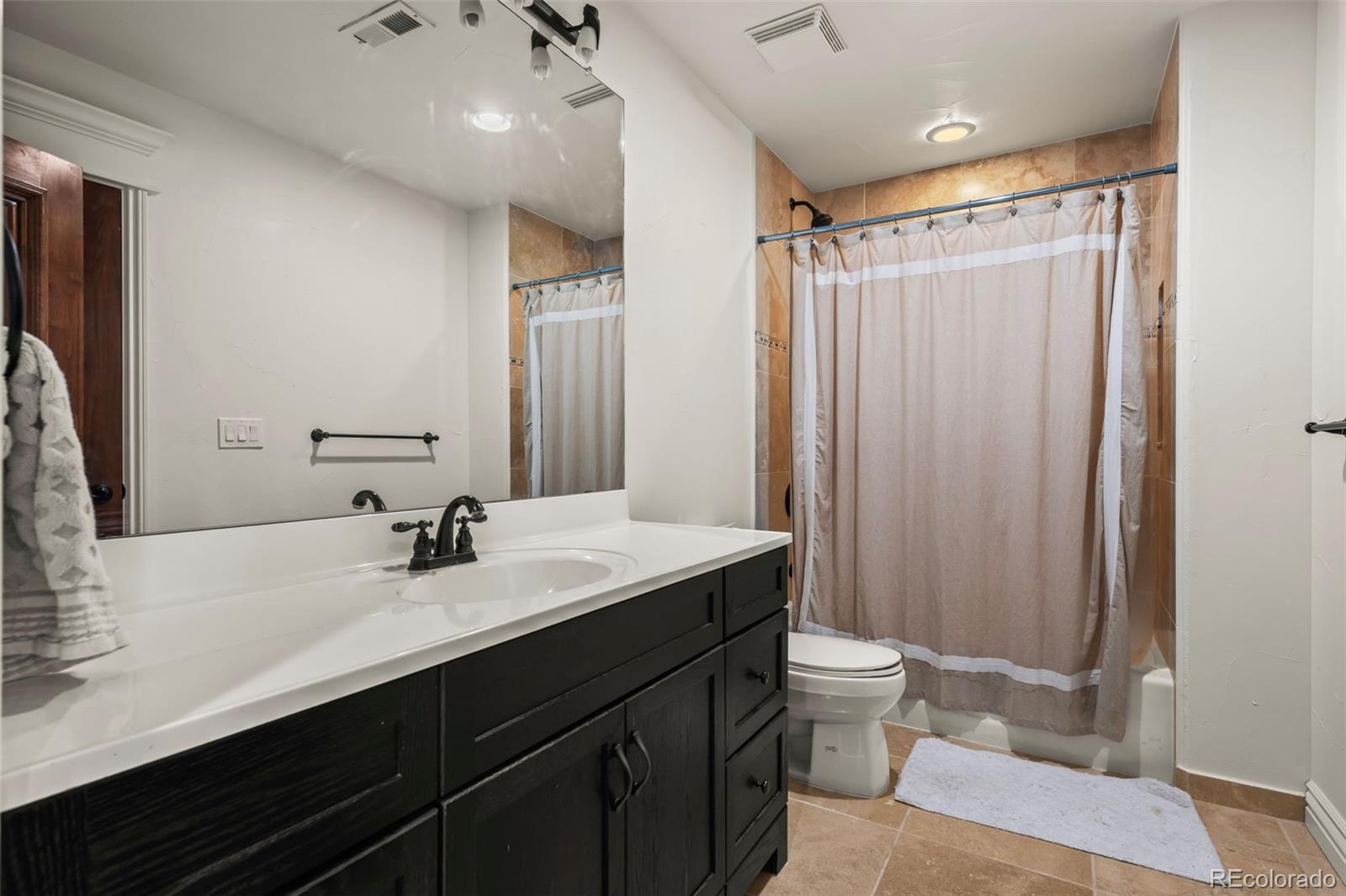 1012 Michener Way Highlands Ranch, CO 80126 - Photo 41 of 50 a bathroom with a double vanity sink toilet and a mirror