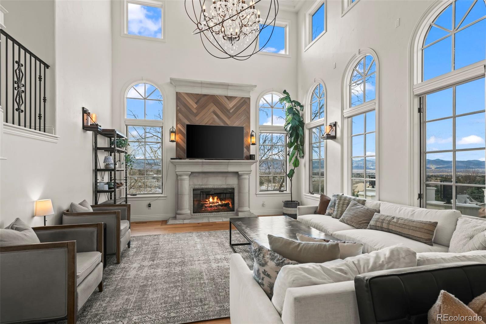 1012 Michener Way Highlands Ranch, CO 80126 - Photo 9 of 50 a living room with furniture a large window and a fireplace
