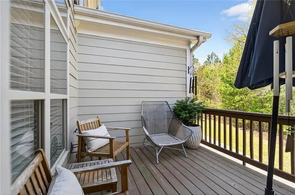 a view of balcony with wooden floor and outdoor seating