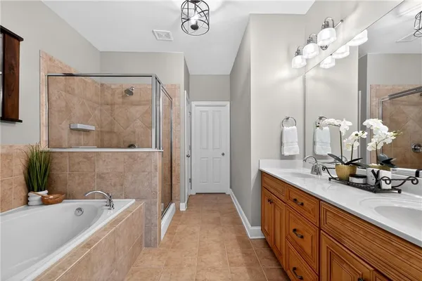 a bathroom with a tub sink and mirror