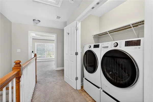 a view of a hallway with washer and dryer
