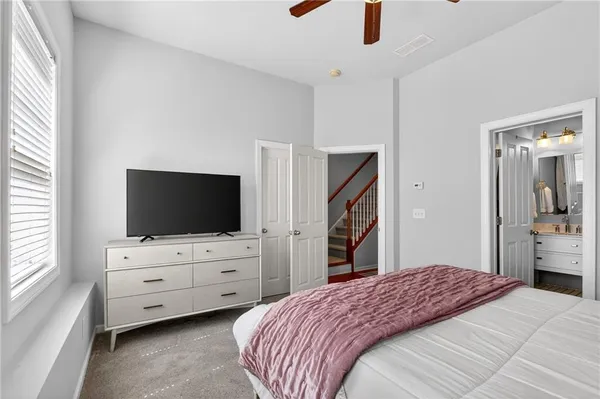 a bedroom with a bed and flat screen tv