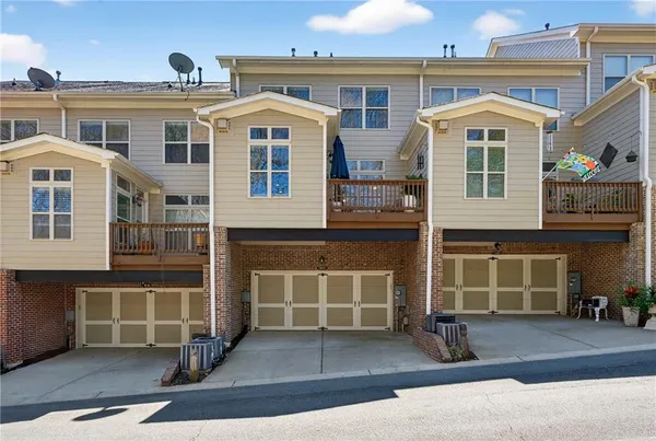 a front view of a house with a yard and parking space