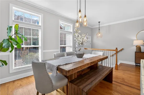 a view of a dining room with furniture and wooden floor