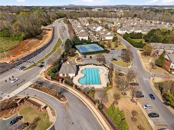 an aerial view of a residential houses with outdoor space
