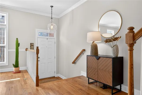 a view of a hallway with entryway wooden floor and front door