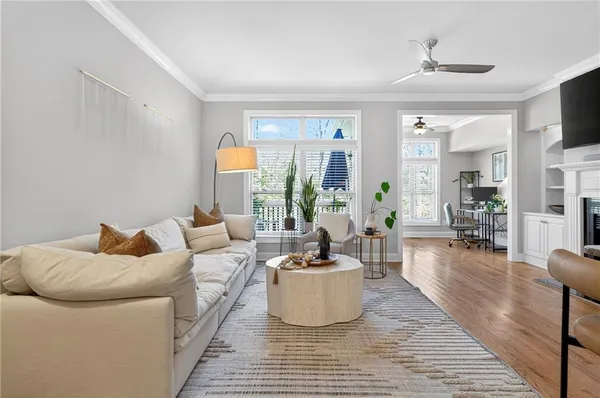 a living room with furniture a rug and a large window