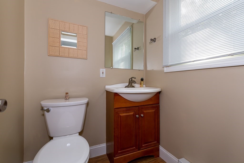 130 Old Ferry Road, Unit B Haverhill, MA 01830 - Photo 14 of 30 a bathroom with a toilet sink and mirror