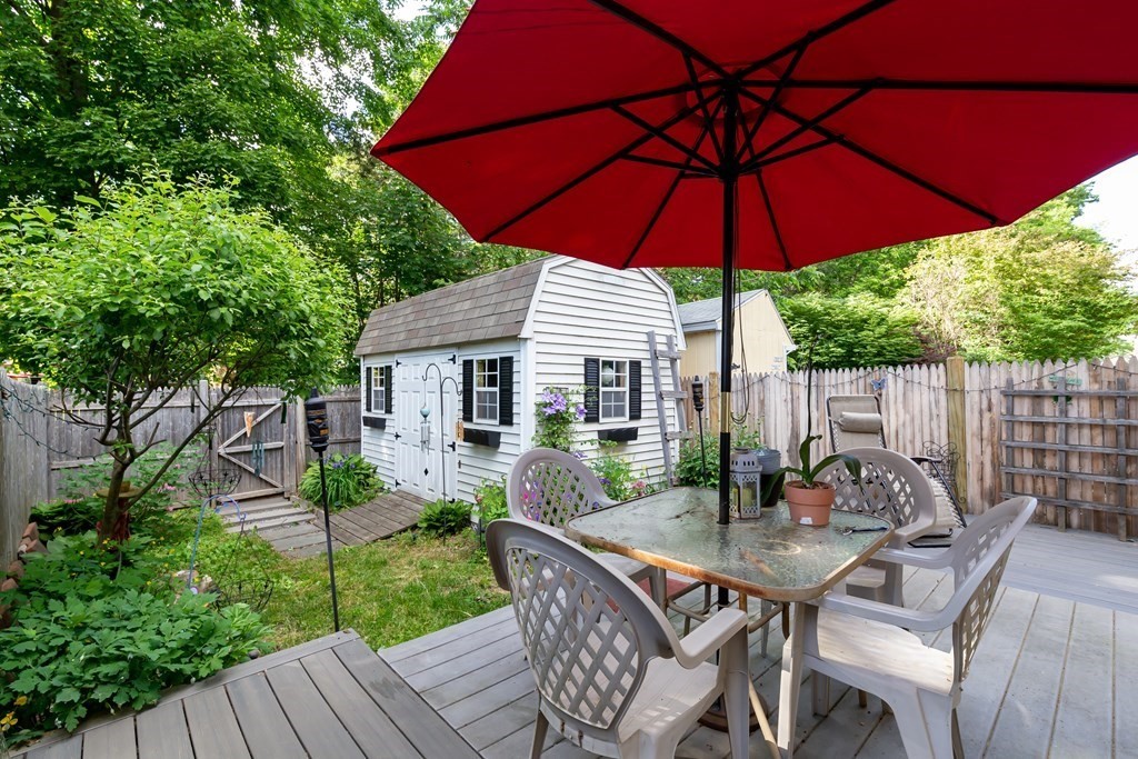 130 Old Ferry Road, Unit B Haverhill, MA 01830 - Photo 7 of 30 a view of a patio with table and chairs under an umbrella