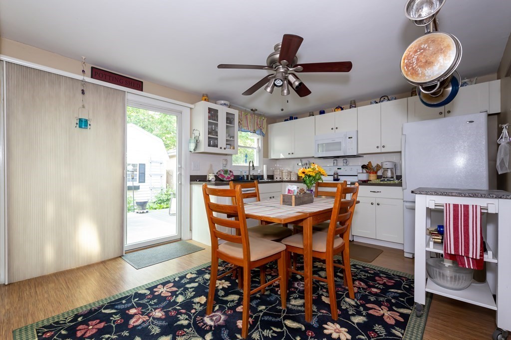 130 Old Ferry Road, Unit B Haverhill, MA 01830 - Photo 9 of 30 a view of a dining room and livingroom with furniture wooden floor a chandelier