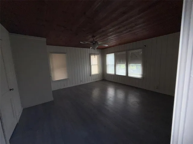 a view of wooden floor and windows in an empty room